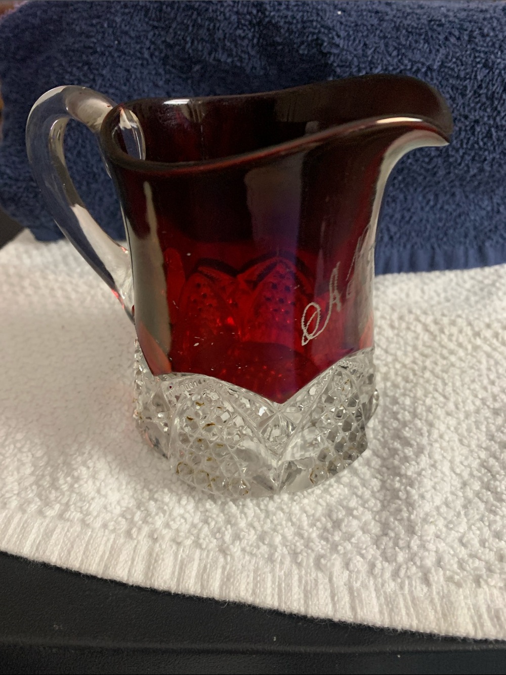 Early souvenir pitcher with ruby flash stain and pressed glass pattern on bottom
